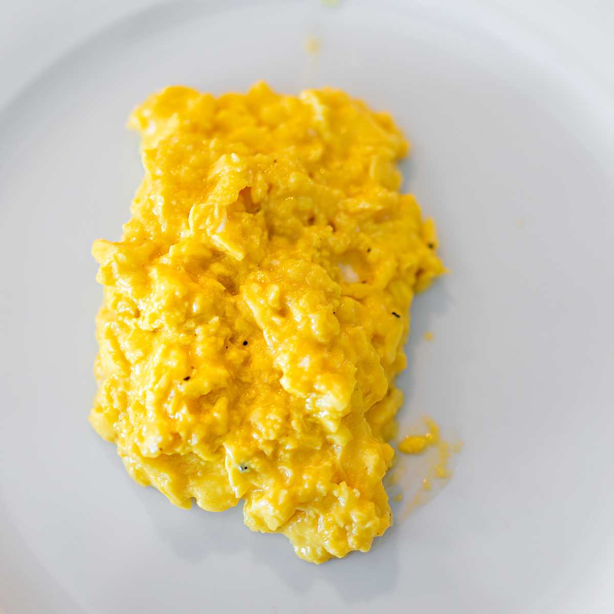 Creamy scrambled eggs on a plate.