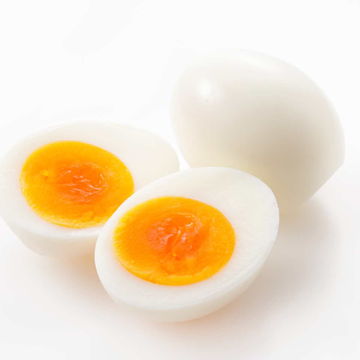 Soft boiled eggs on a white background.