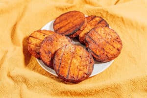 Tofu burger patties on a plate.