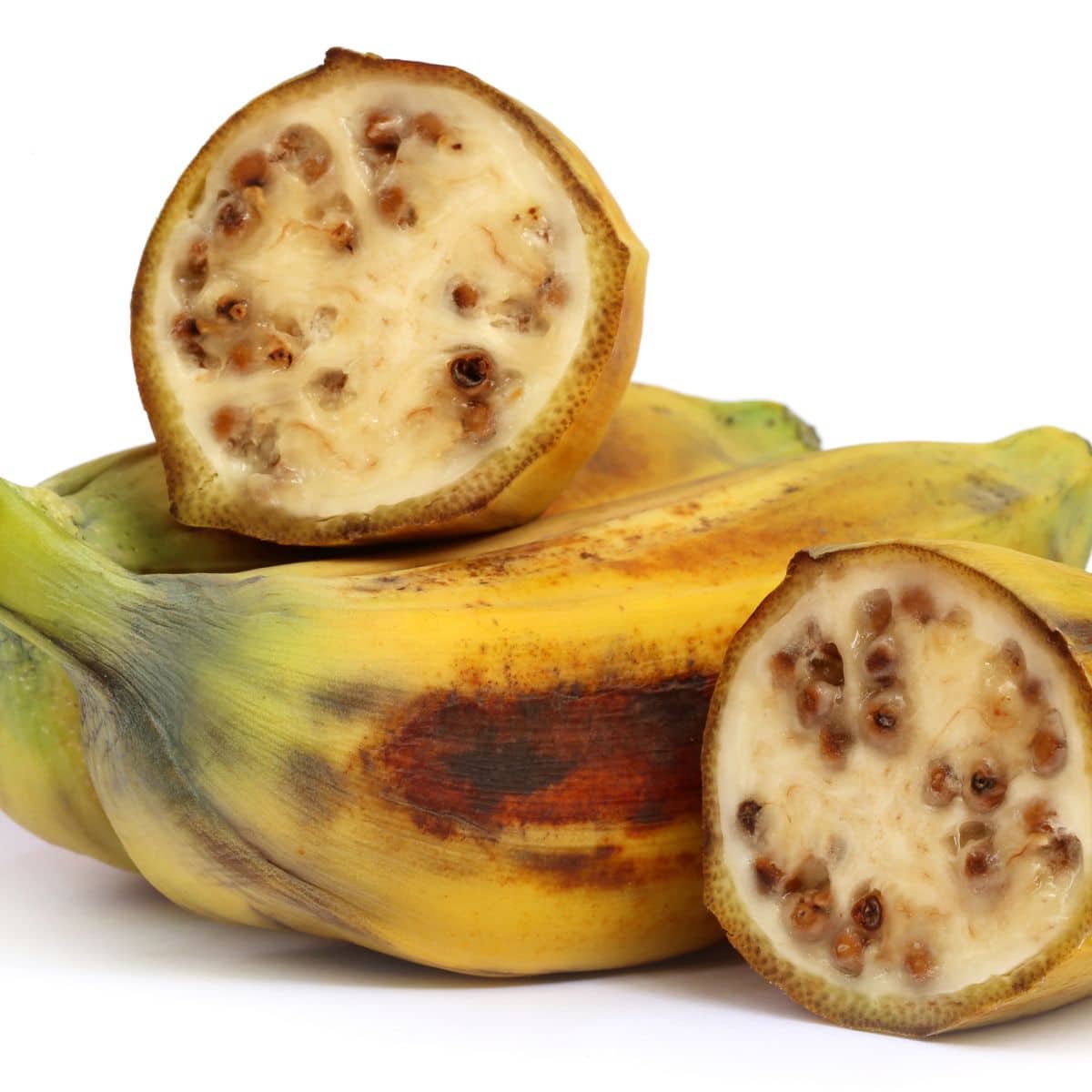 Wild bananas on a white background sliced open.