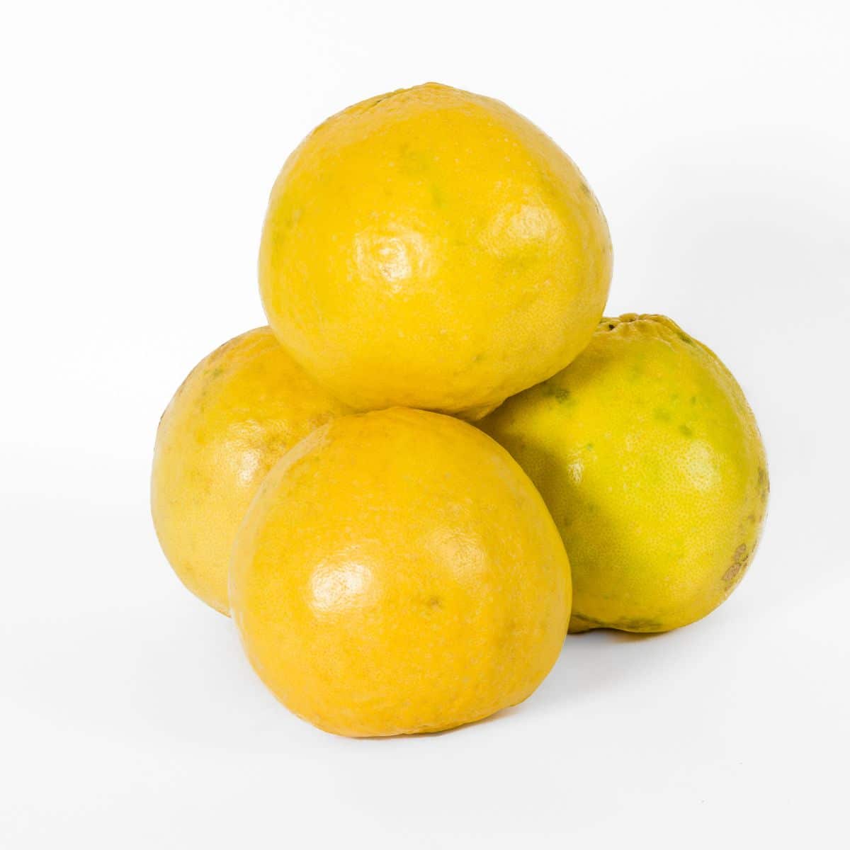 A stack of wild lemons on a white background.