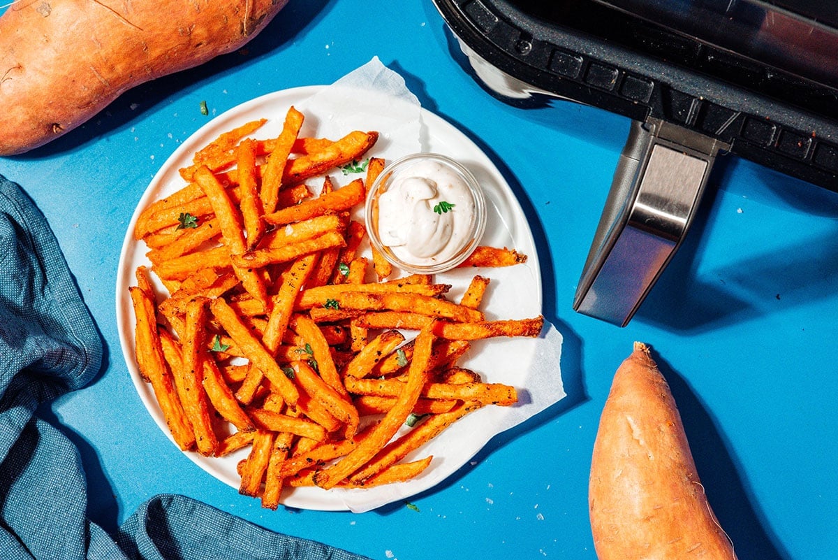 Air fryer frozen sweet potato fries on a plate.