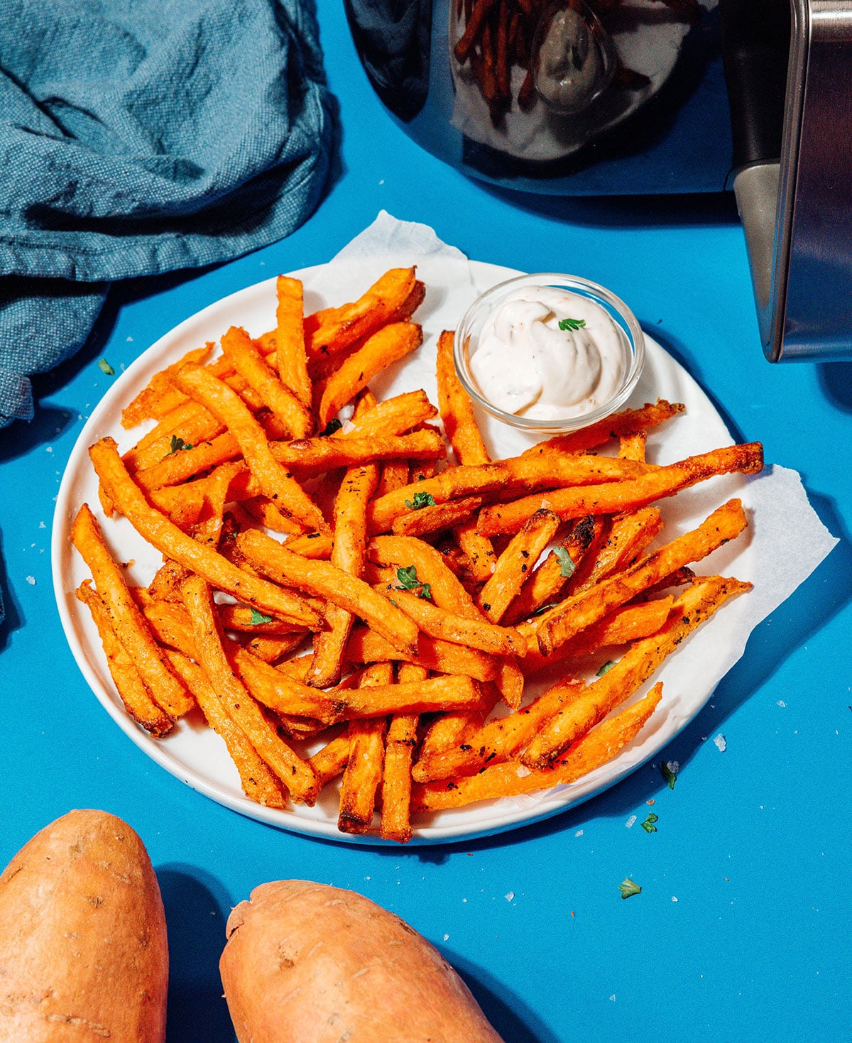 Air fryer frozen sweet potato fries on a plate.