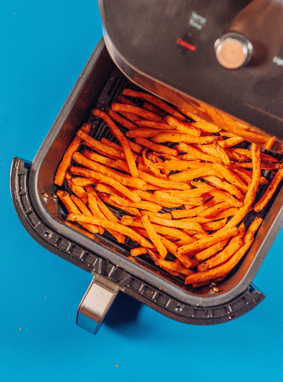 Frozen sweet potato fries in an air fryer.