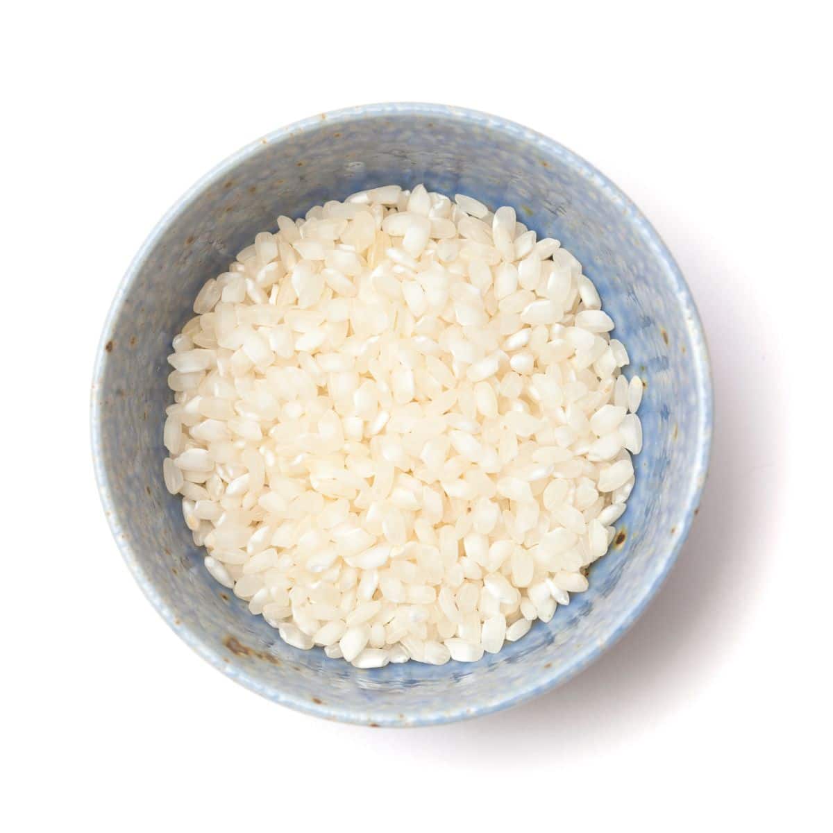 Bomba rice in a bowl on a white background.