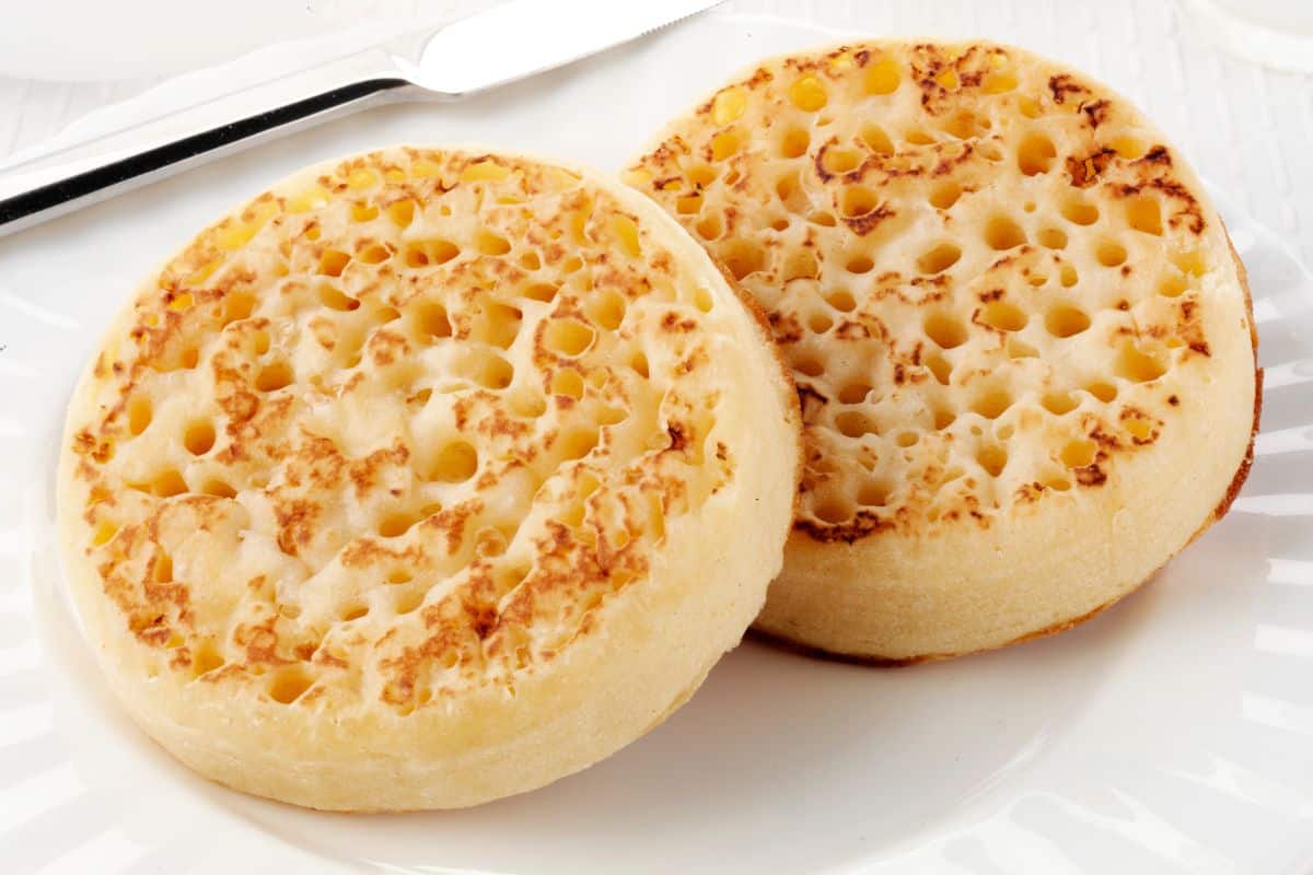 Crumpets on a white plate.