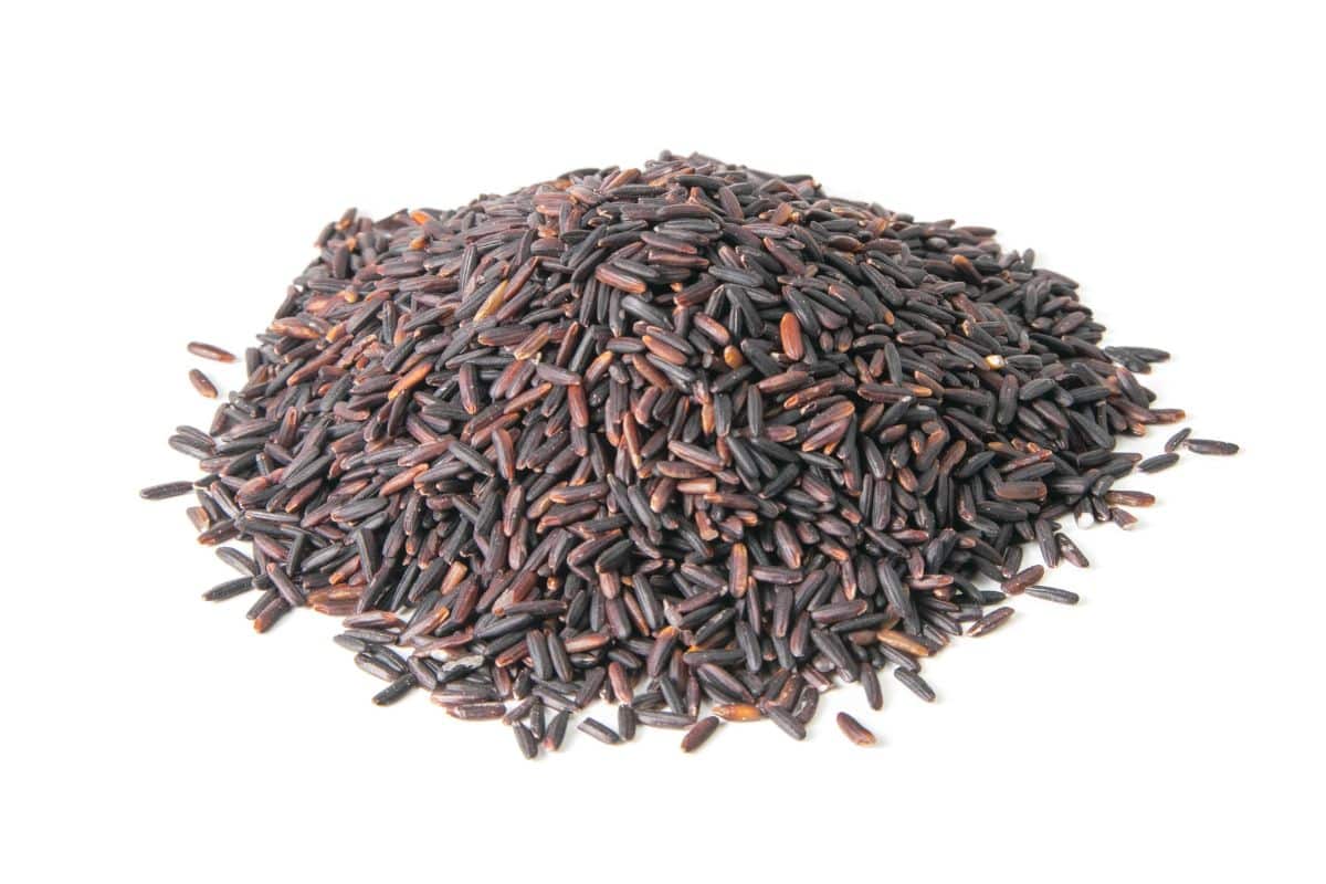 Indonesin black rice on an isolated white background.
