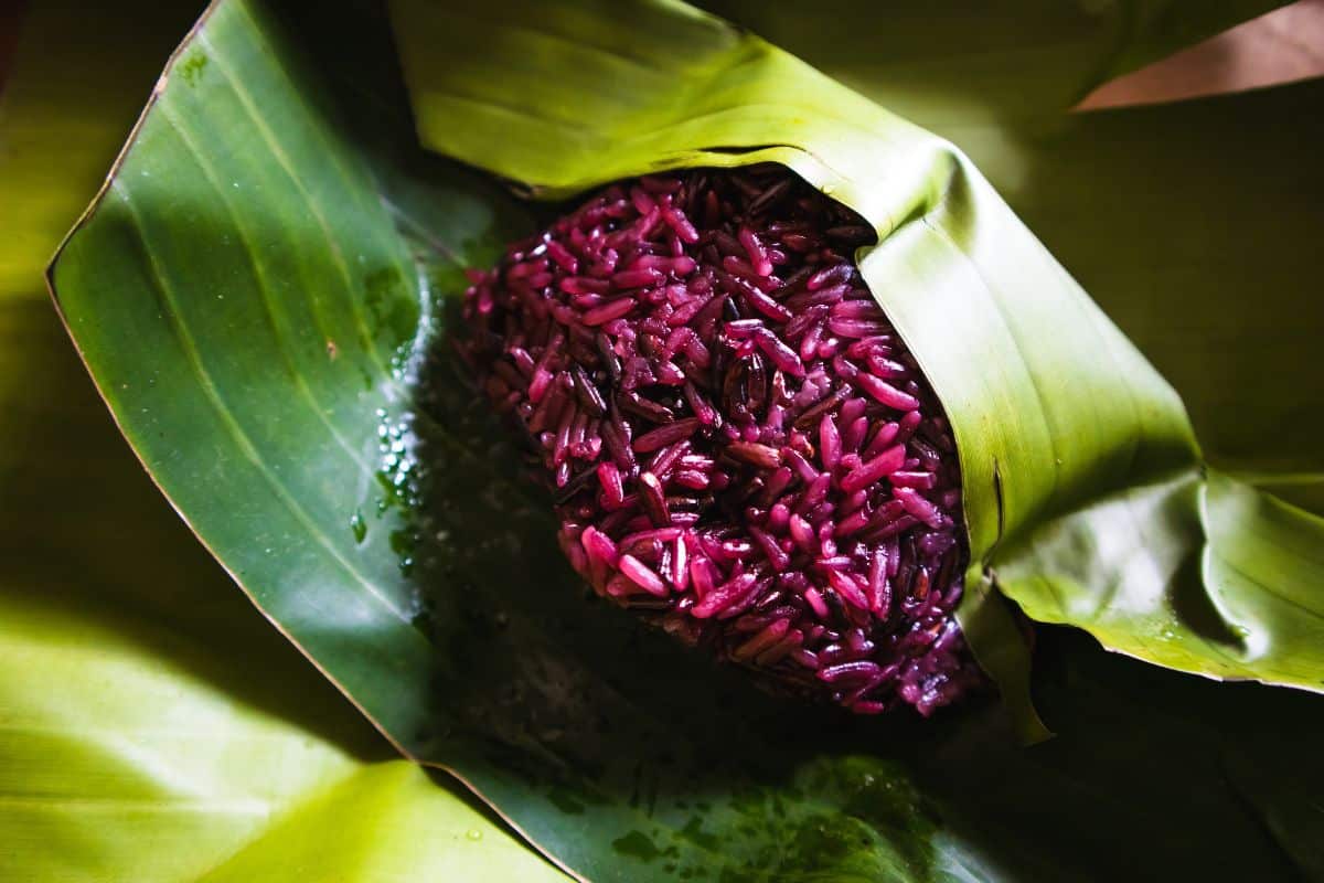 Purple sticky rice in banana leaves.