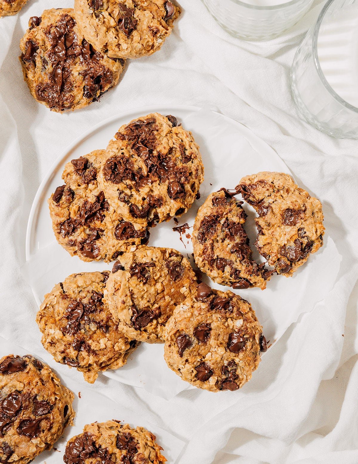 Sweet potato cookies with oats and chocolate on a white tablecloth.