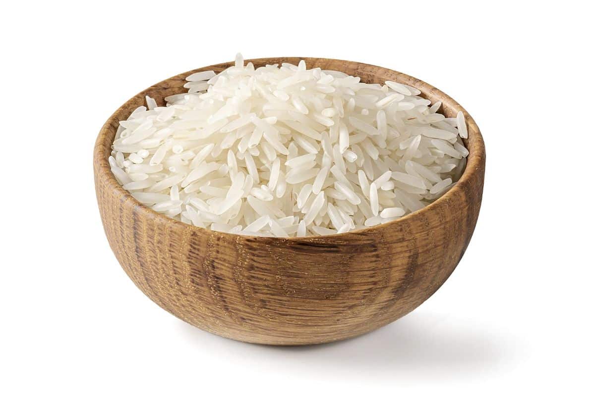 Texmati rice in a wood bowl on a white background.
