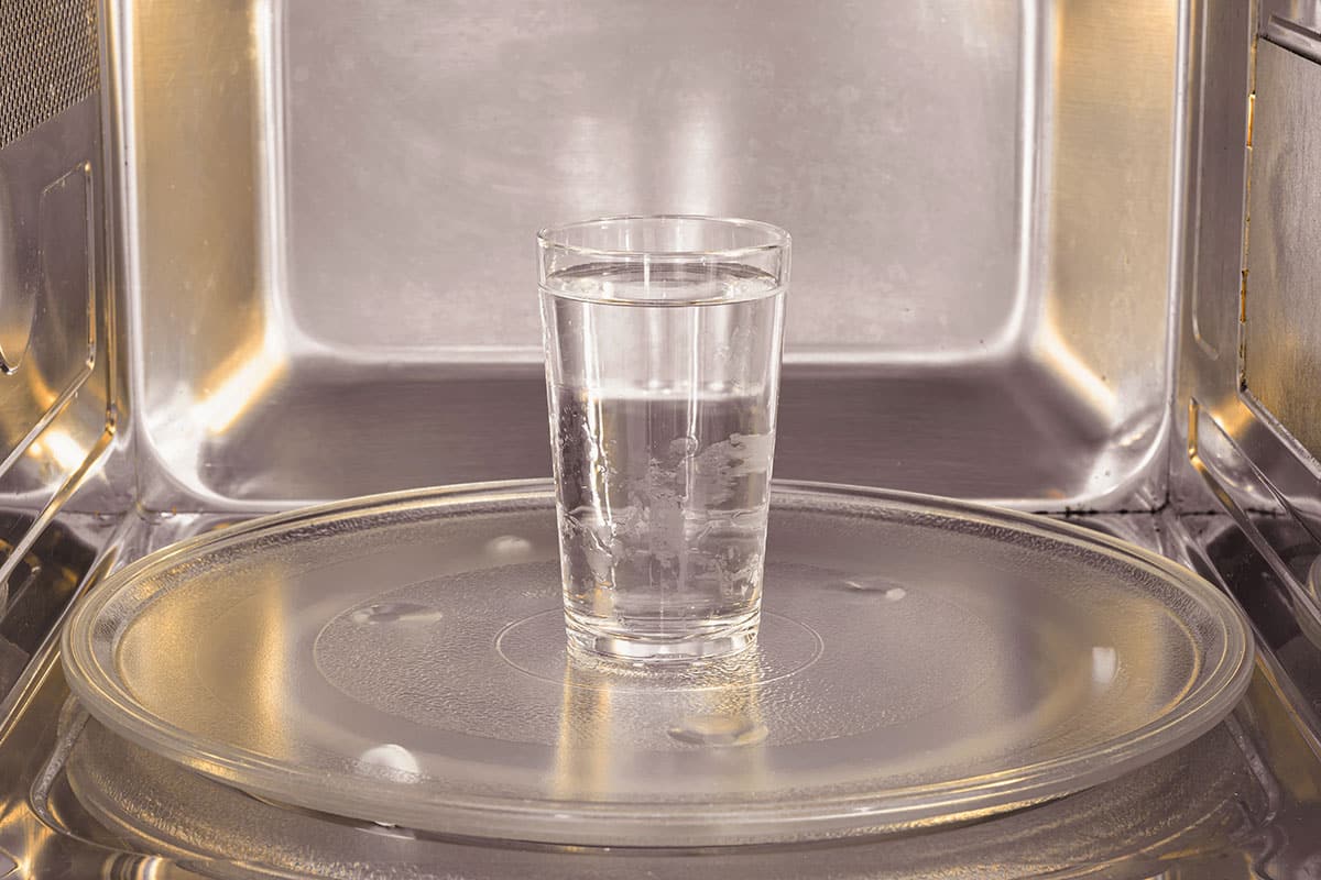 Water in a glass in the microwave.