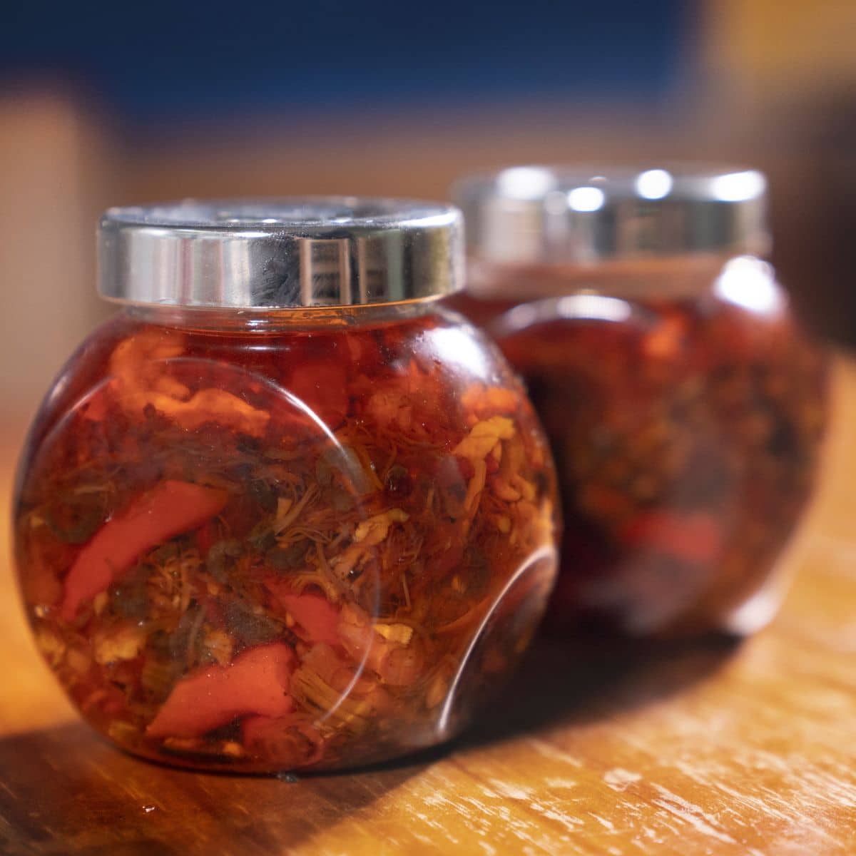 To jars of xo sauce on a table.