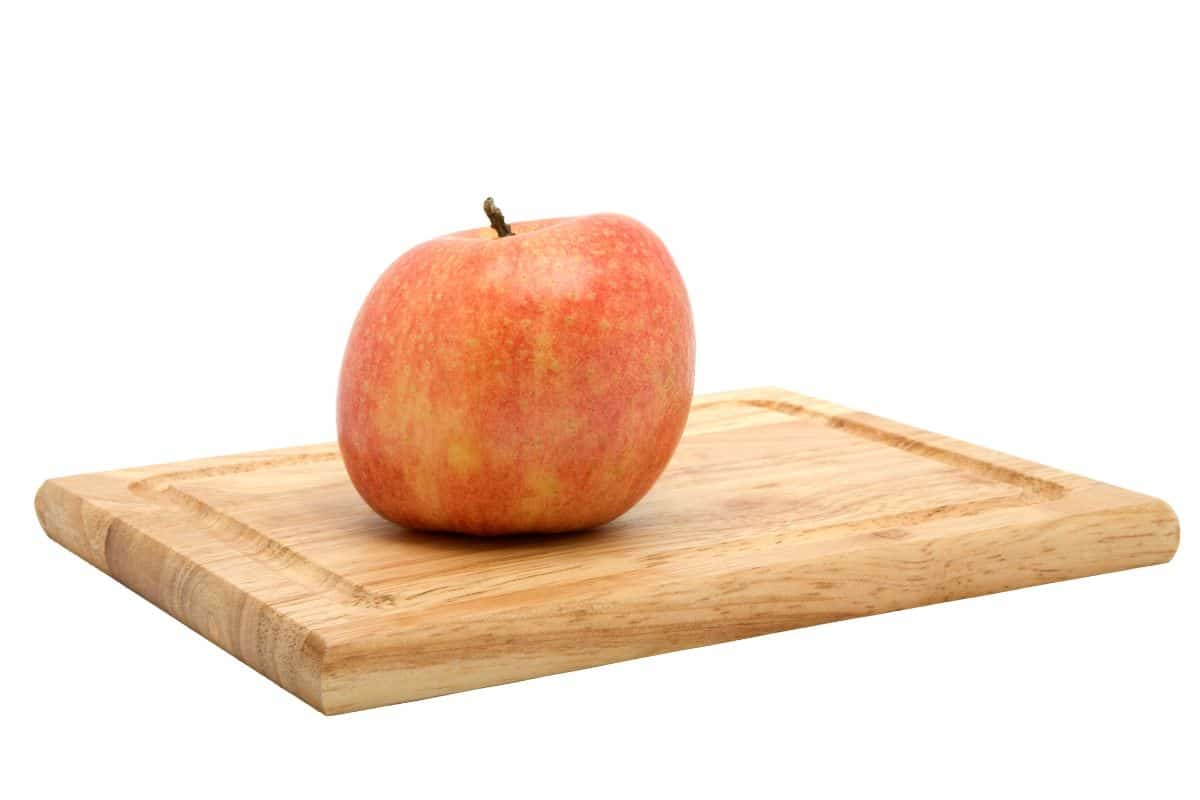 A york apple on a wood board.