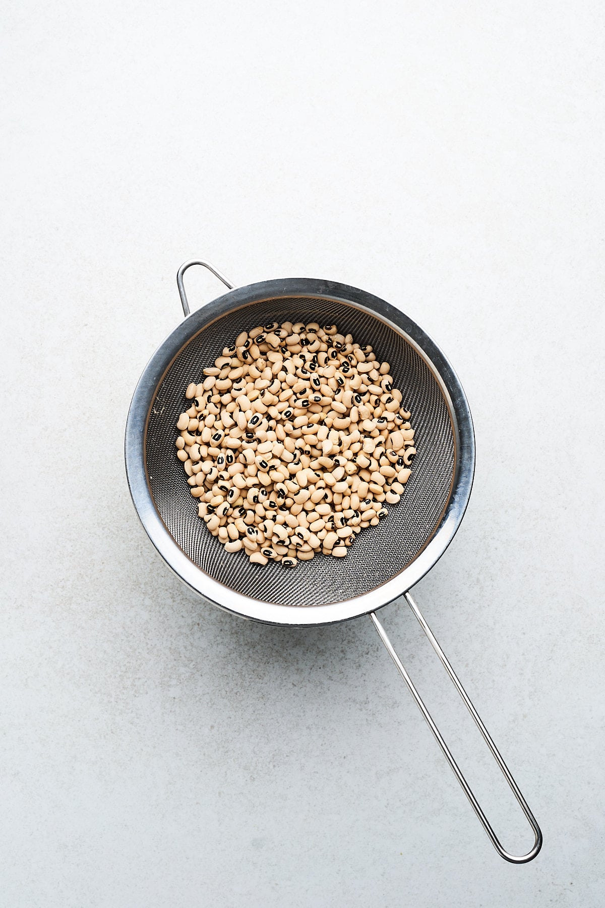 Black eyed peas in a strainer.
