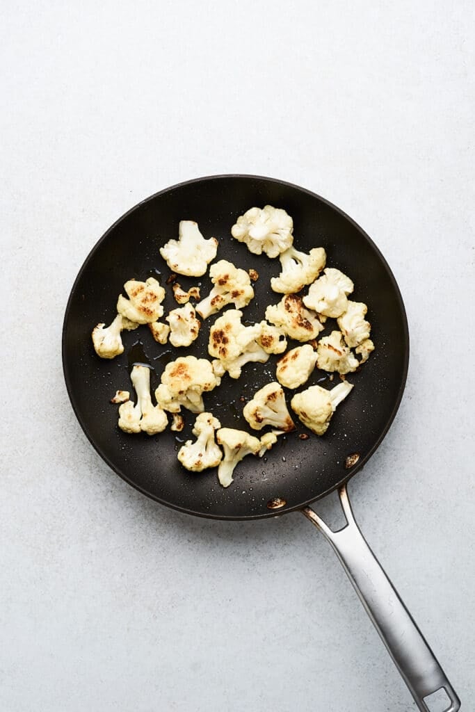 Cooked cauliflower in a skillet.