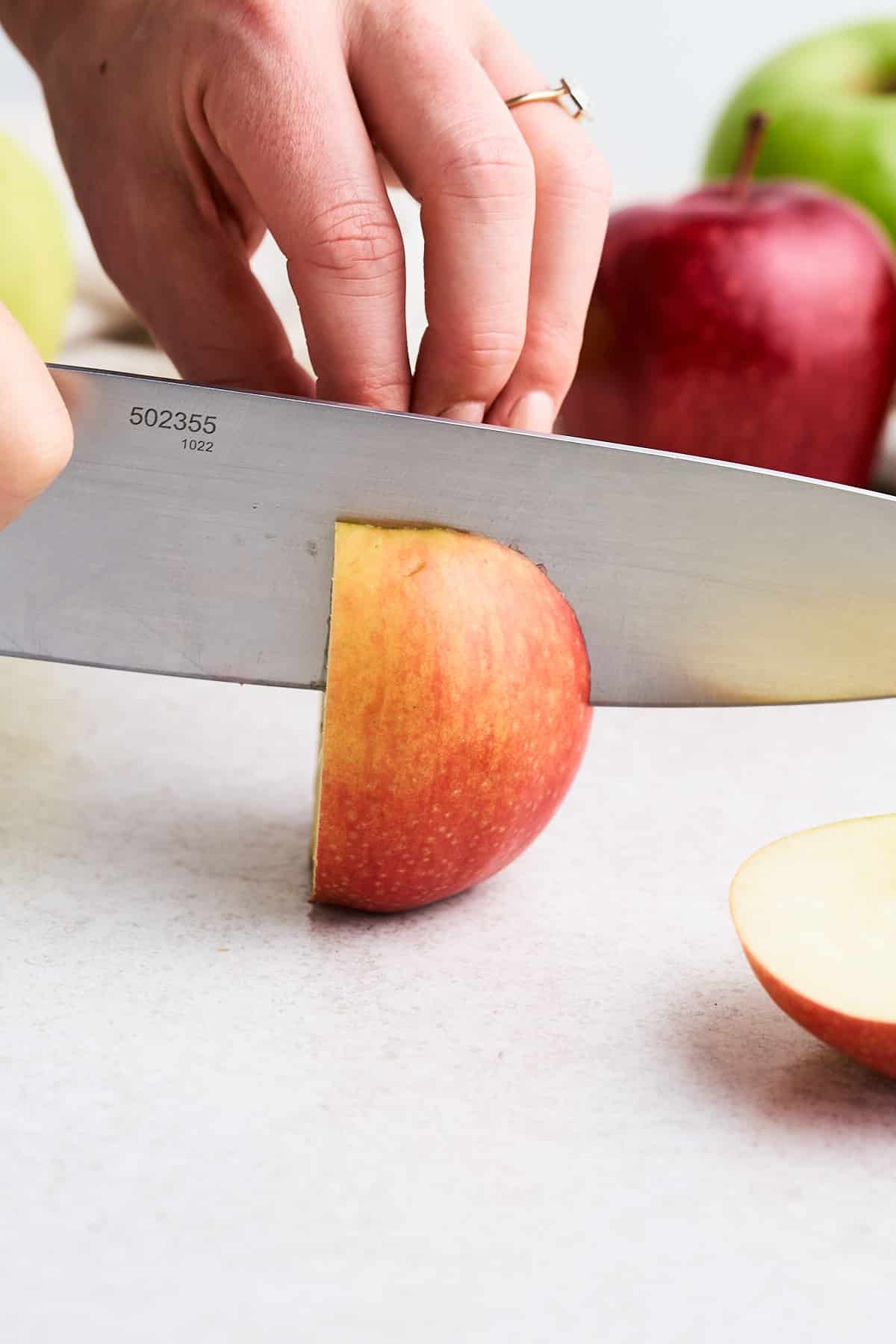 Slicing an apple vertically.