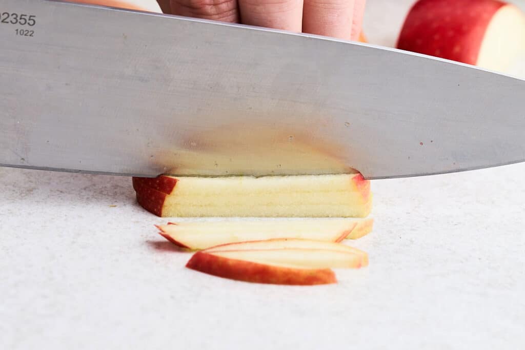 Cutting an apple into matchsticks.