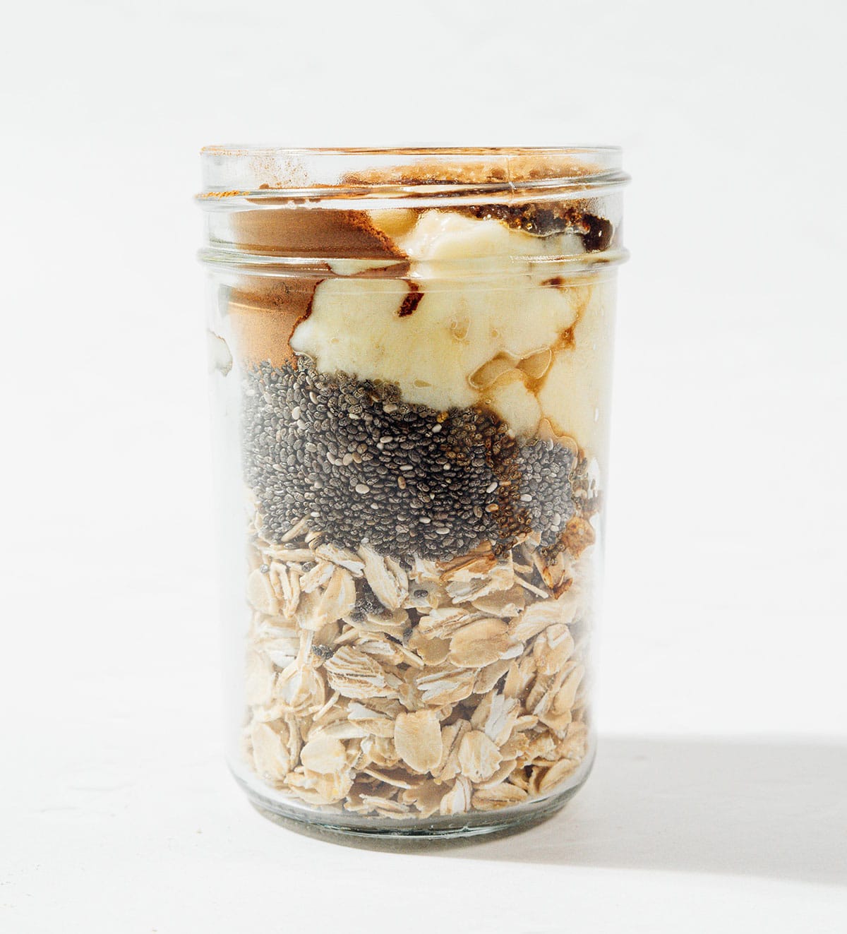 Ingredients for banana overnight oats in a jar.