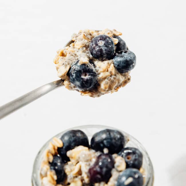 Spoon of blueberry overnight oats.