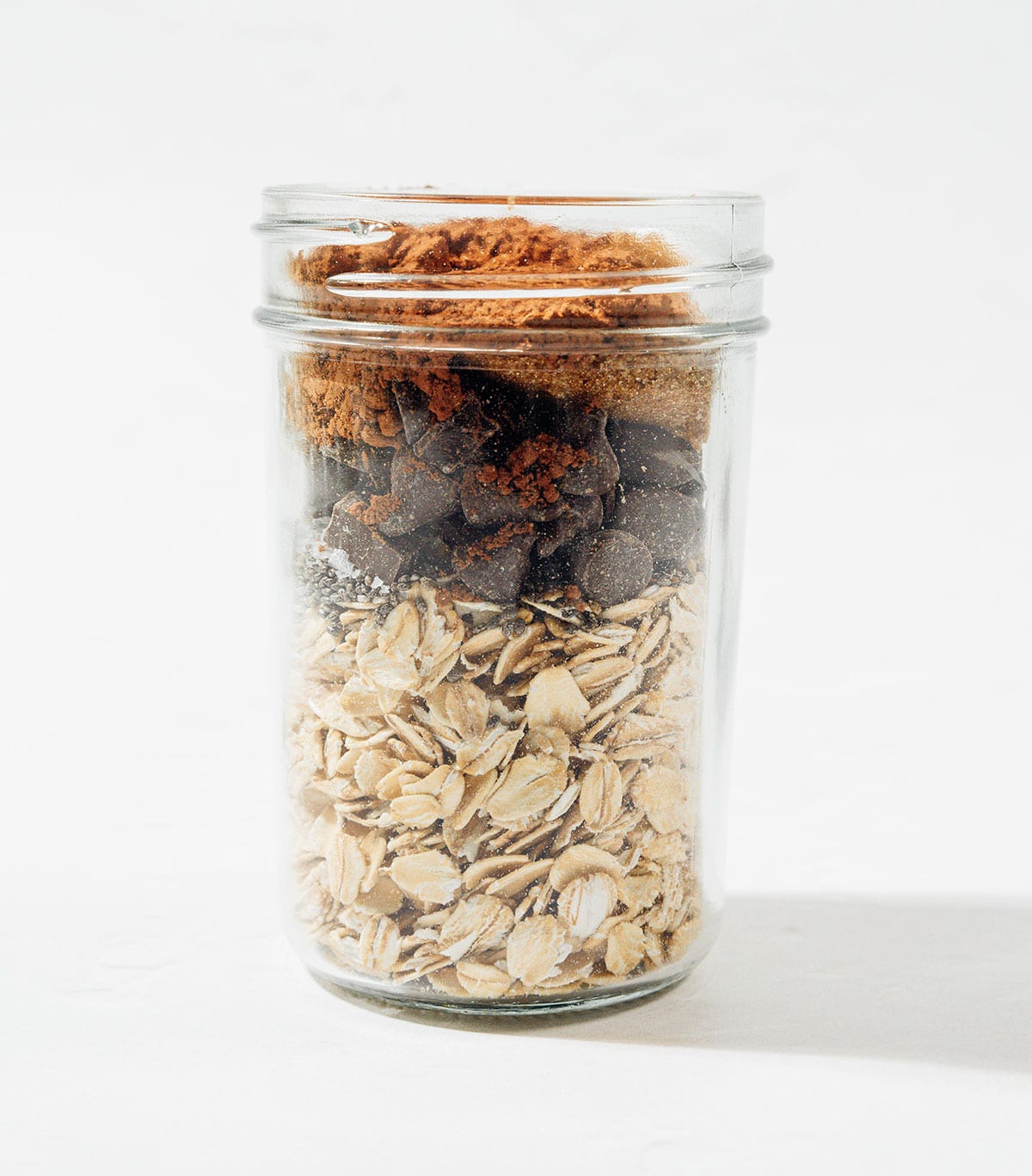 Ingredients for chocolate overnight oats in a jar.