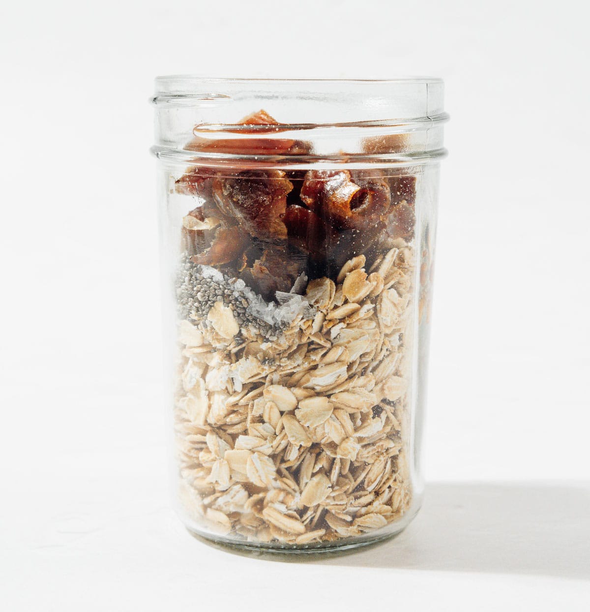 Ingredients for date overnight oats in a jar.