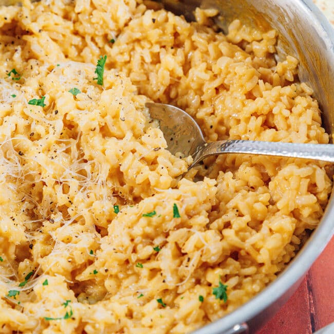 Risotto in a pan with a spoon.