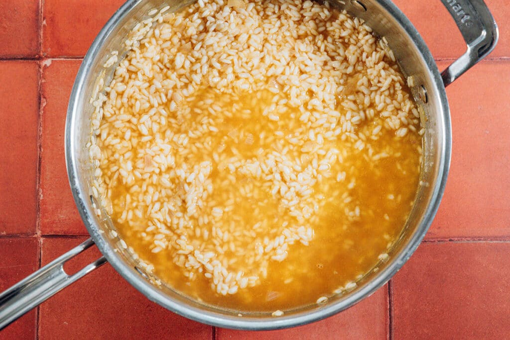 Making risotto in a pan.