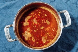 Lentils and broth in a pot.
