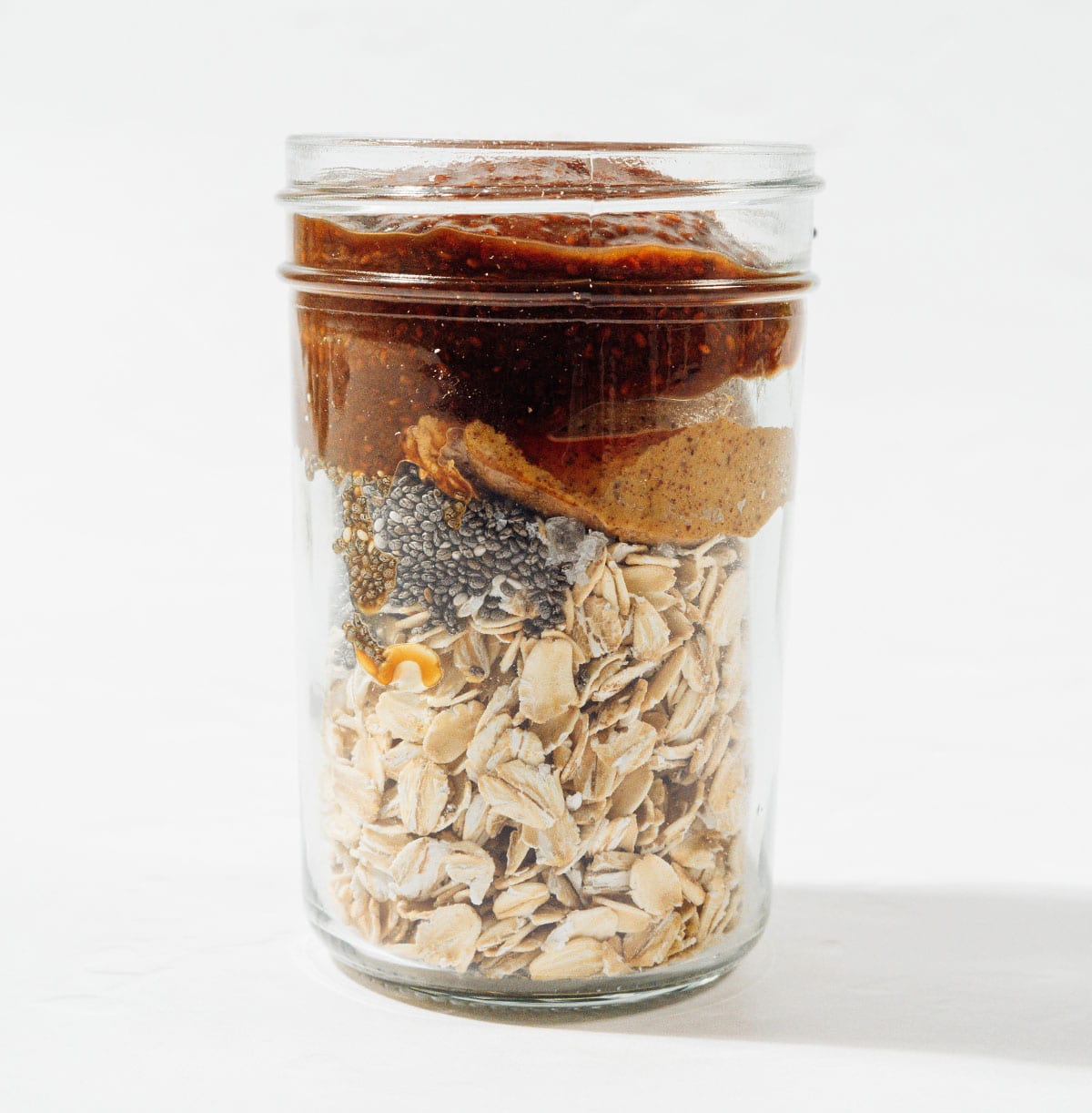 Ingredients for PB & J overnight oats in a jar.