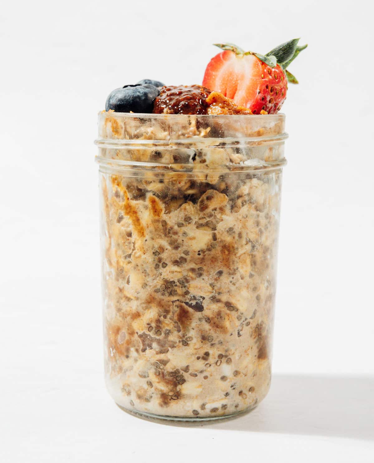 Ingredients for PB & J overnight oats in a jar.