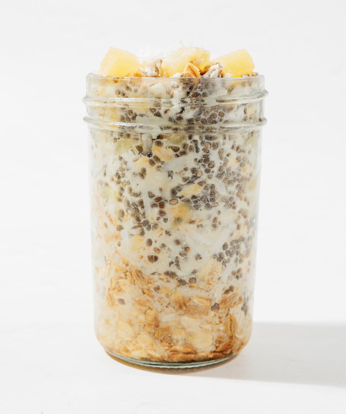 Ingredients for pineapple overnight oats in a jar.