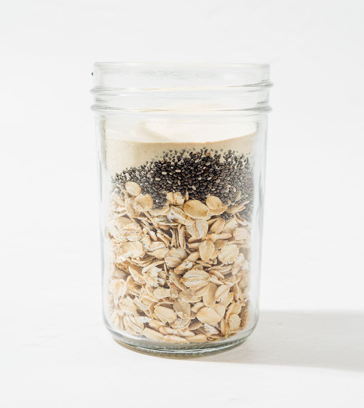 Ingredients for protein overnight oats in a jar.