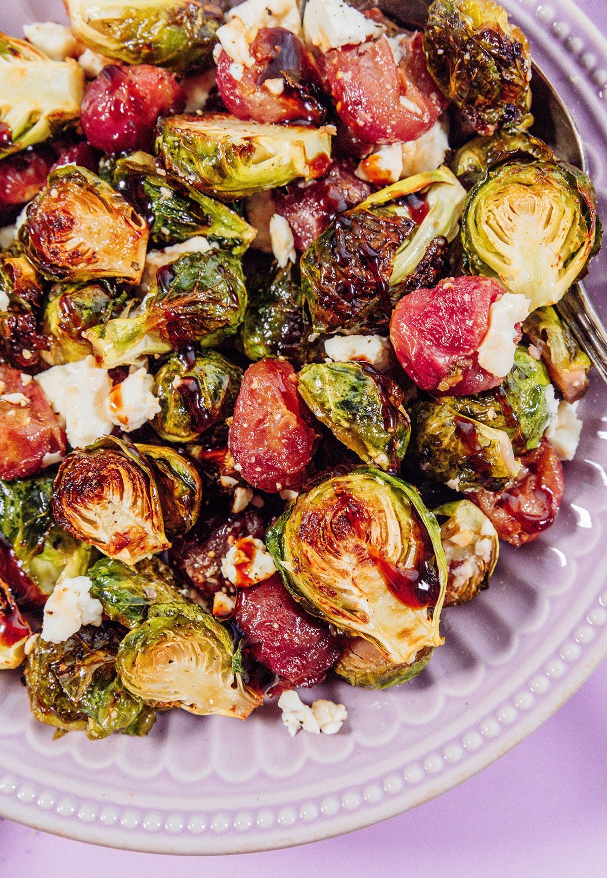 Roasted Brussels sprouts with grapes on a plate.
