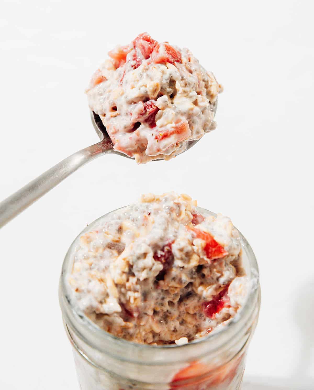 Spoon of strawberry overnight oats.