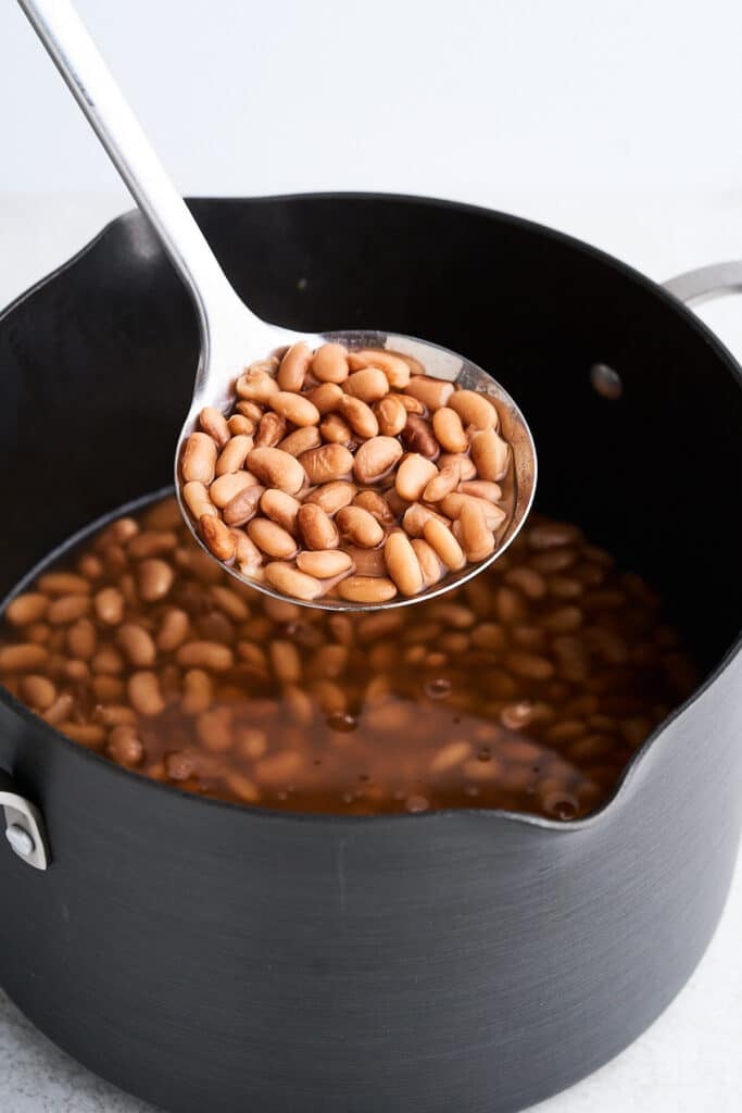 Cooked pinto beans in a pot.