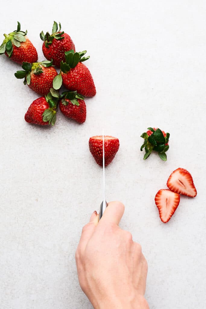 Cutting strawberries.