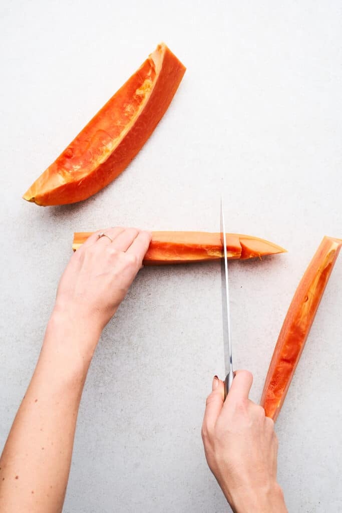 Cutting a papaya.