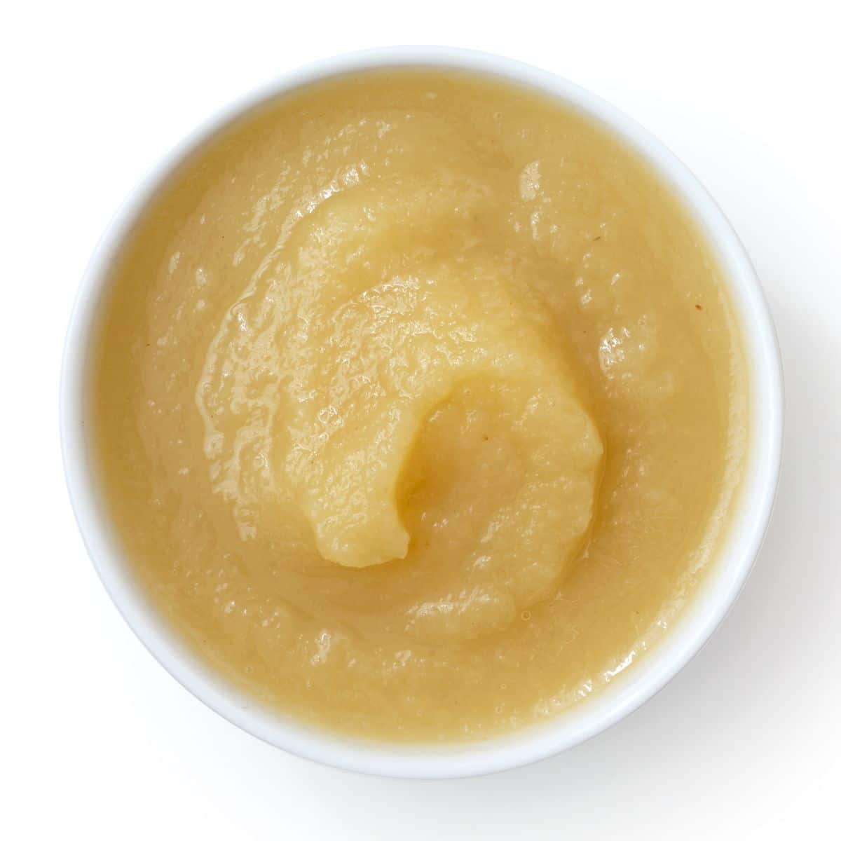 Applesauce in a bowl on a white background.