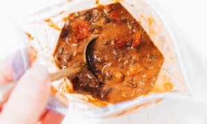Spoon in a bag of thawed chili.