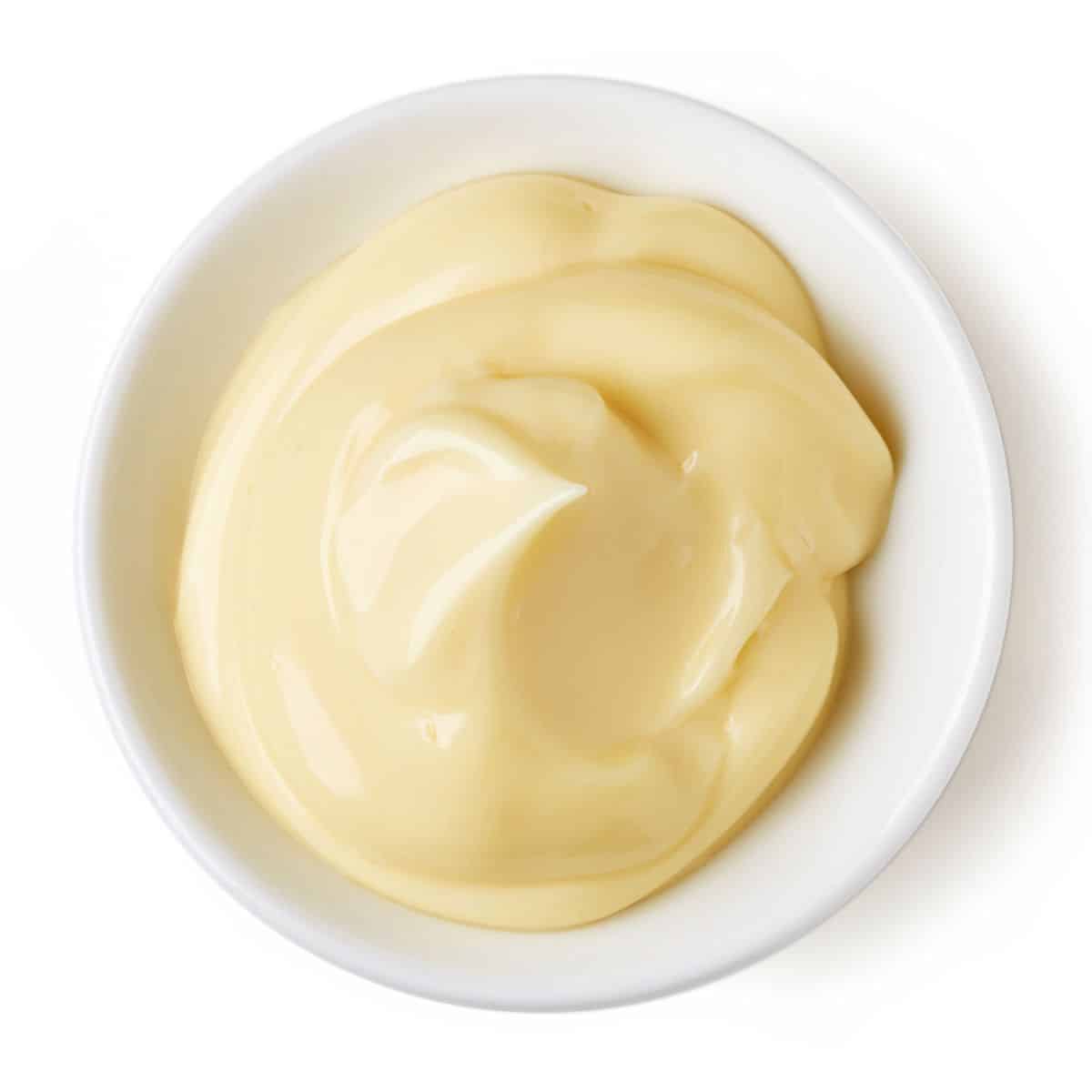Mayo in a bowl on a white background.