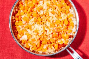 Carrots and onion in a pan.