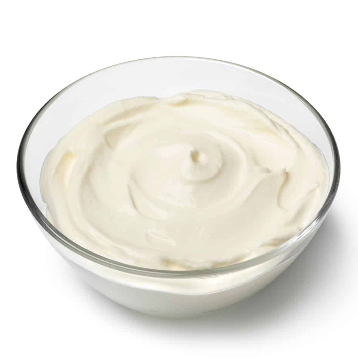 Creme fraiche in a bowl on a white background.
