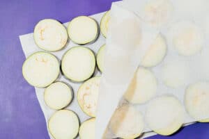 Drying eggplant with paper towels.