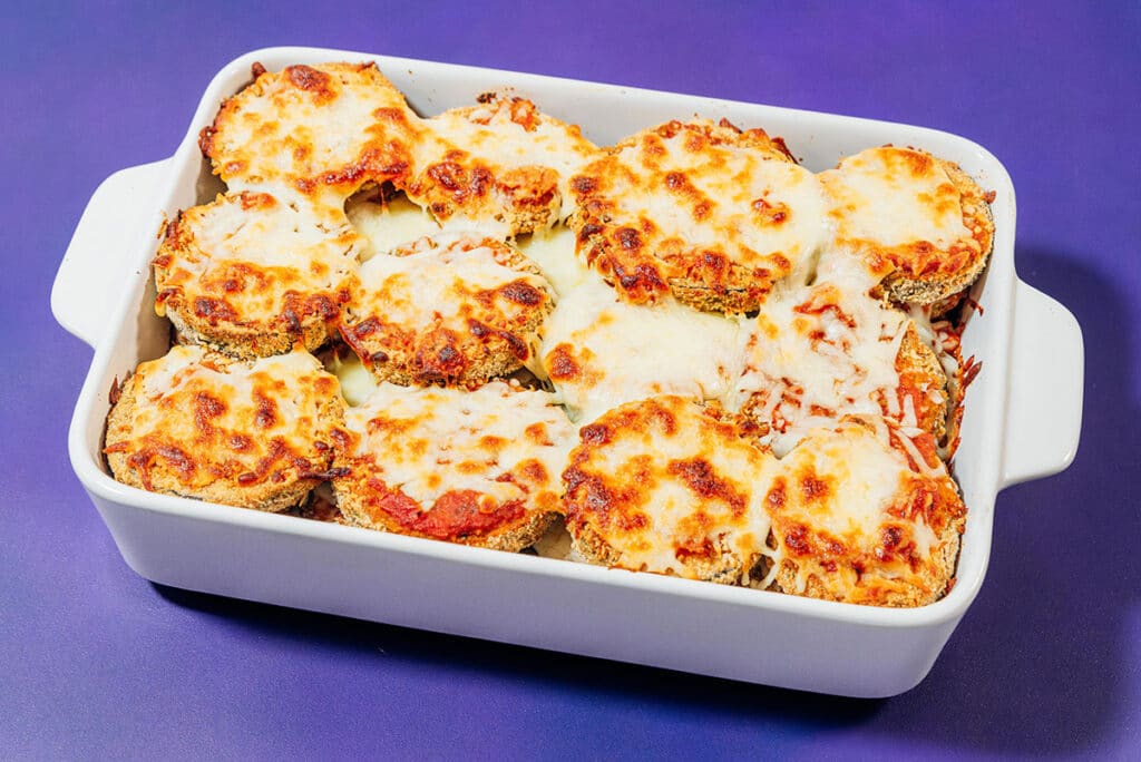 Cooked eggplant parmesan in a baking dish.