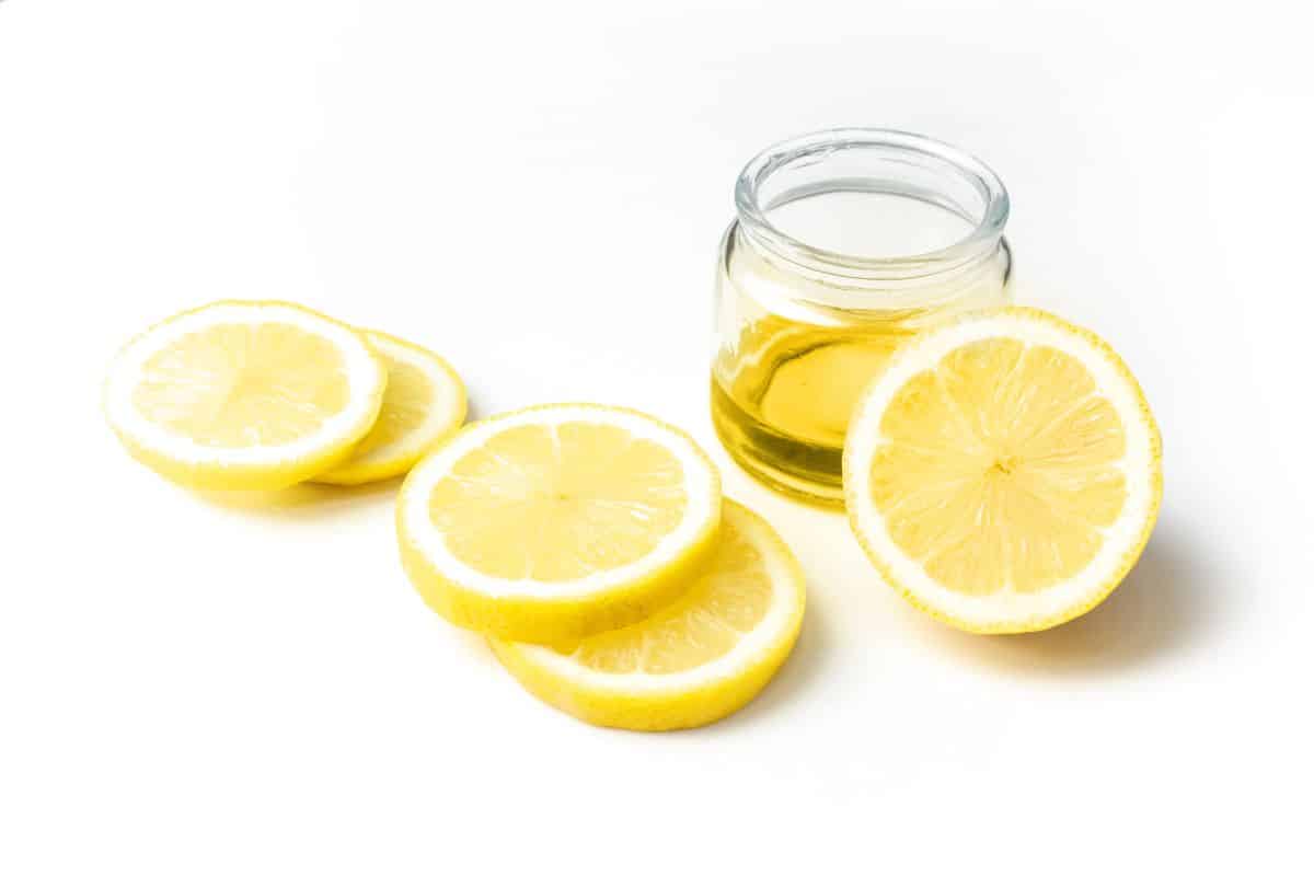 Lemon extract in a jar on a white background.