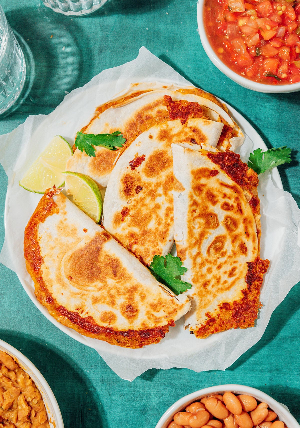 Bean and cheese tacos on a plate.