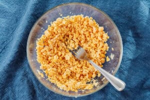 Smashing chickpeas with a fork.