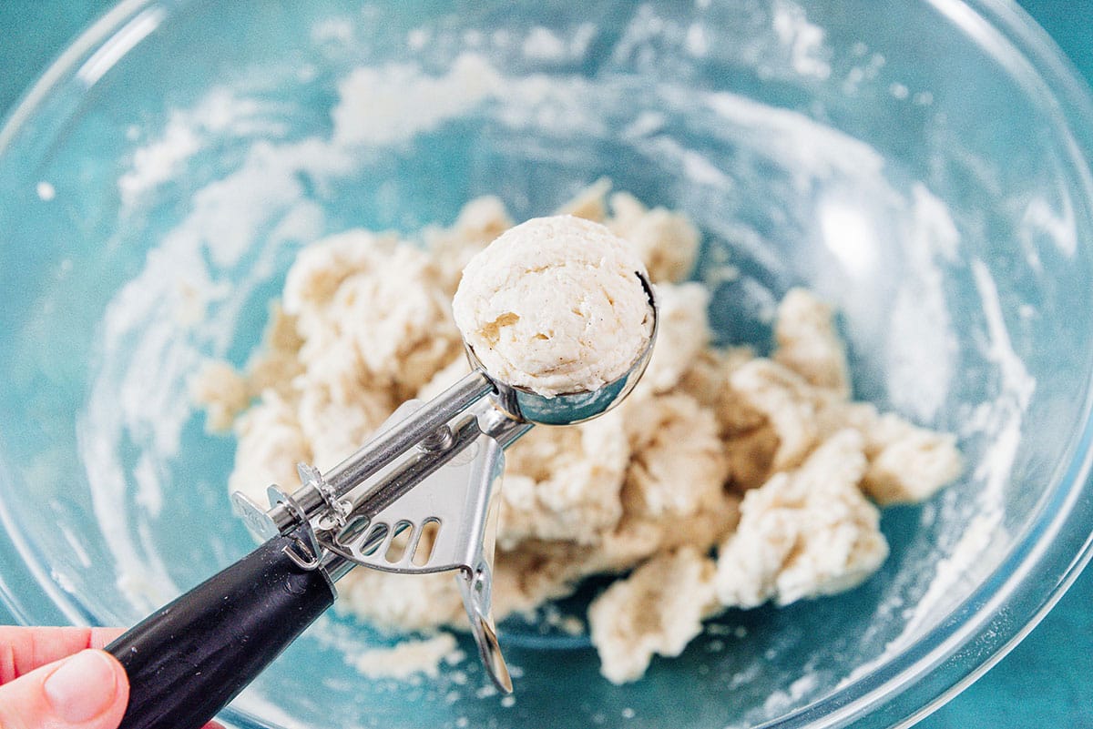 Scooping dumpling dough with a scooper.