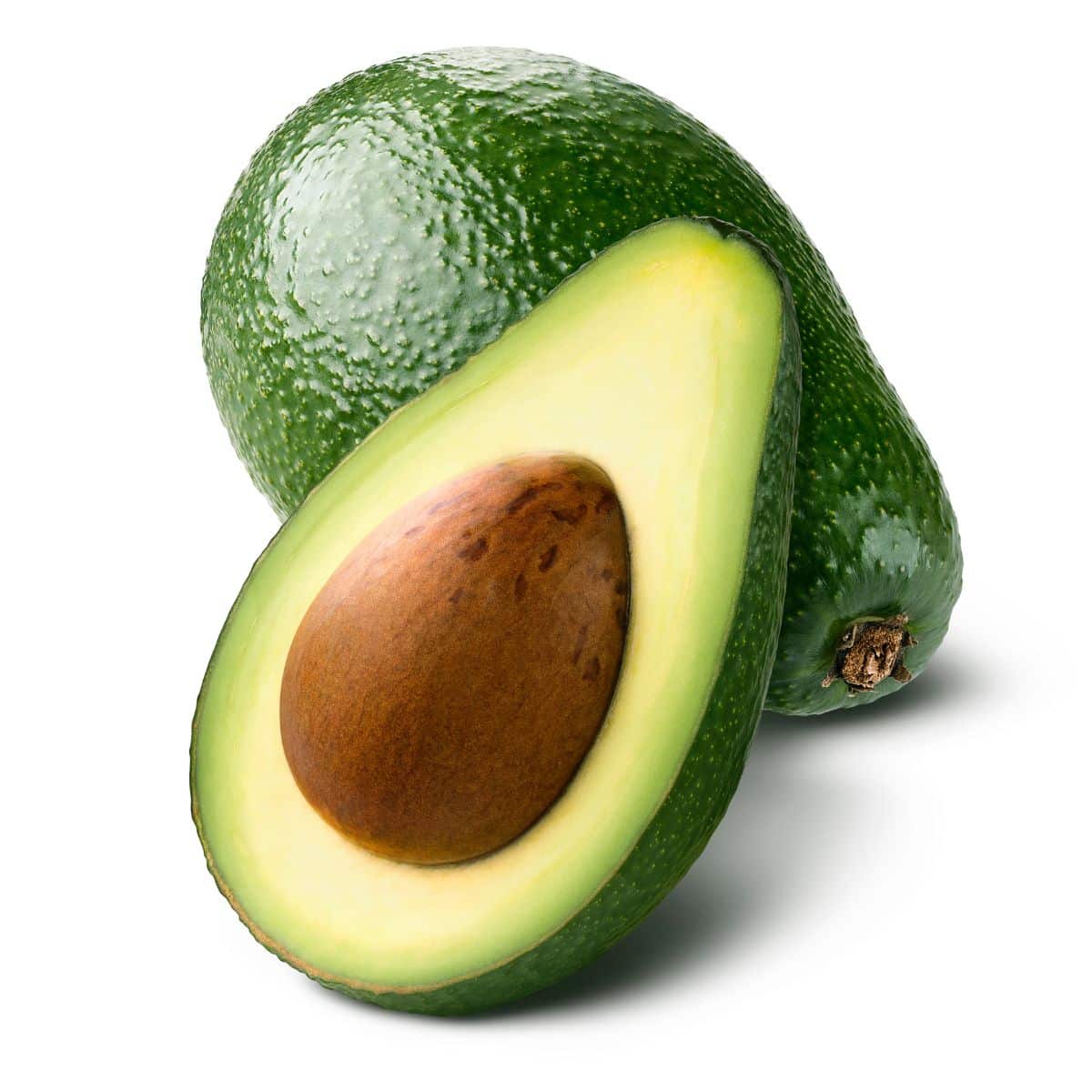 A cut open rincon avocado on. white background.