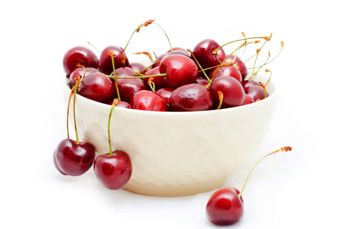 Sweetheart cherries in a bowl on. white background.